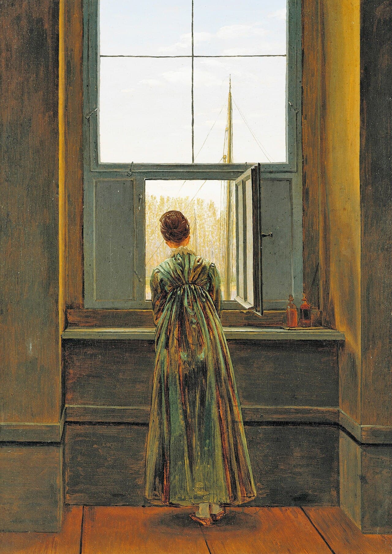 Caspar David Friedrich, Kobieta w oknie (1822, Alte Nationalgalerie w Berlinie) — ciemna izba wyłożona brązowym drewnem, z rudymi deskami podłogi. Smukła kobieta w zielonej sukni stoi plecami do widza, wsparta o parapet, i wychyla się w uchylone dolne skrzydło okna; za szybami widać maszt z olinowaniem, pas żółknących drzew na drugim brzegu i chmury, a z prawej strony parapetu stoją dwie małe buteleczki.