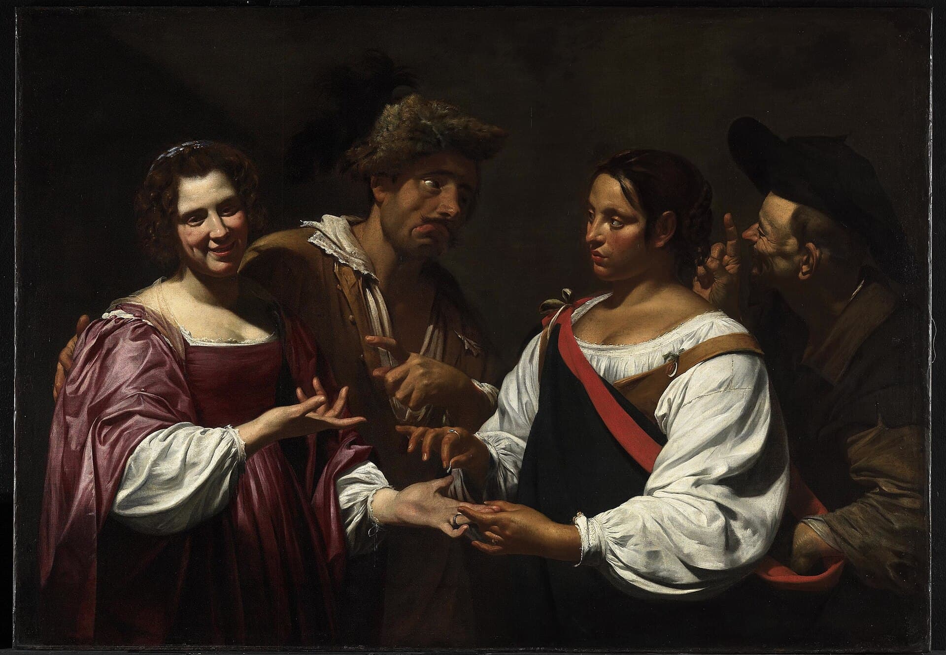 Simon Vouet, Wróżka (ok. 1617) — Cyganka czyta dłoń młodzieńca, a jej wspólniczka po cichu opróżnia mu kieszeń