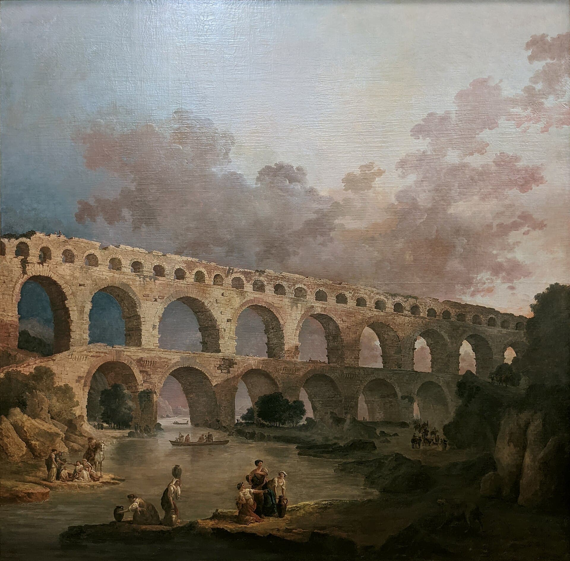 Hubert Robert, Le Pont du Gard (1787) — potężny, trzypiętrowy rzymski akwedukt z kamiennych arkad przerzucony nieprzerwaną linią przez szeroką dolinę rzeki; u jego podnóża maleńkie ludzkie postacie oddają ogrom infrastruktury wzniesionej, by pokonać odległość