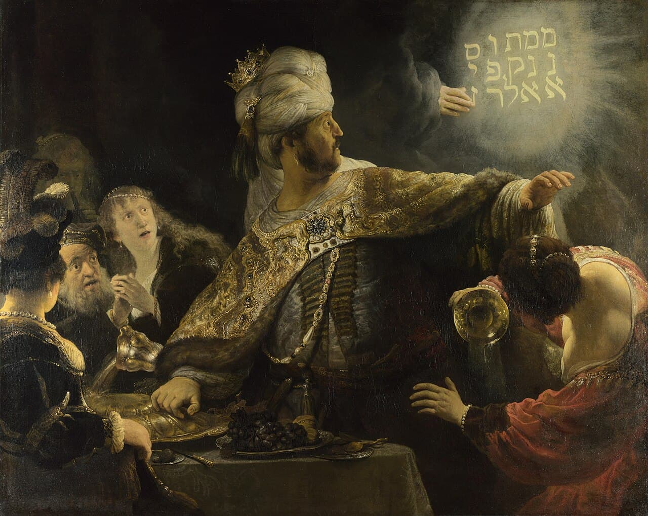Rembrandt, Uczta Baltazara ok. 1635-38, National Gallery - w mroku rozświetlonym złotem babiloński król Belzazar w bogatym płaszczu i turbanie odwraca się z wytrzeszczonymi oczami od świetlistej dłoni, która kreśli na ścianie hebrajski napis; biesiadnicy w popłochu, a król nie rozumie, że czyta własny wyrok